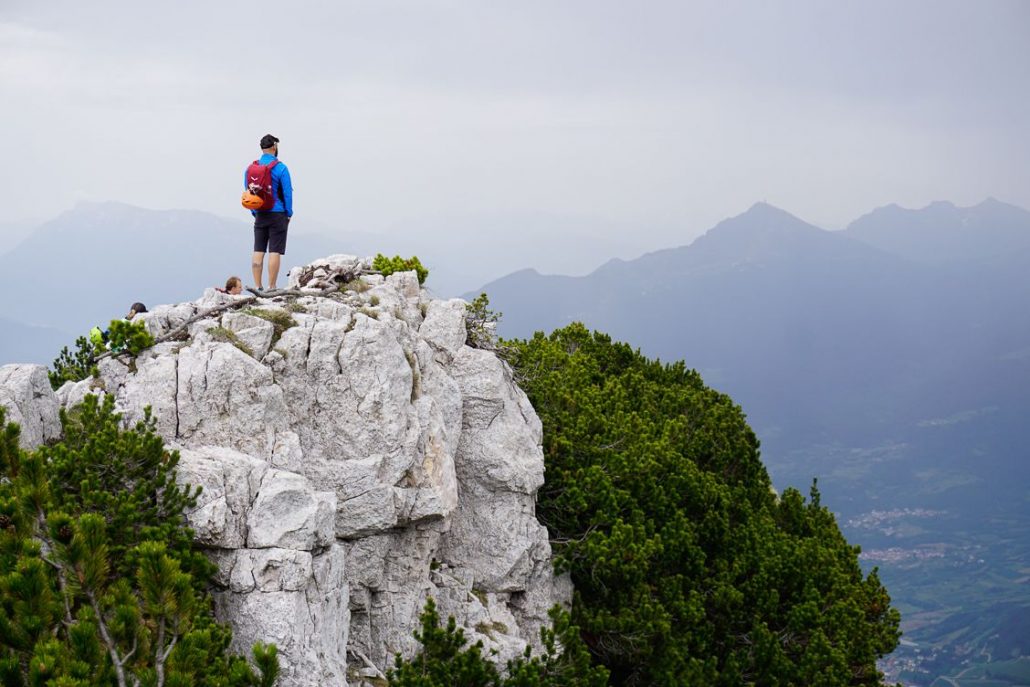 Man looking out across the Paganella Dolomites above Andalo