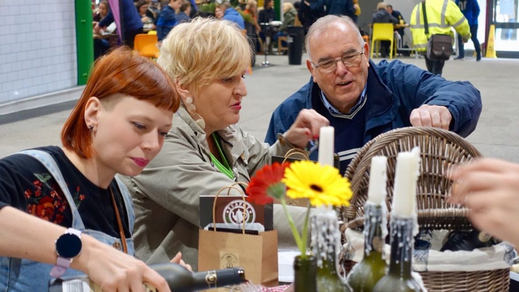 Alice Teacake eating and drinking with friends on Leeds Food Tours inside Kirkgate Market