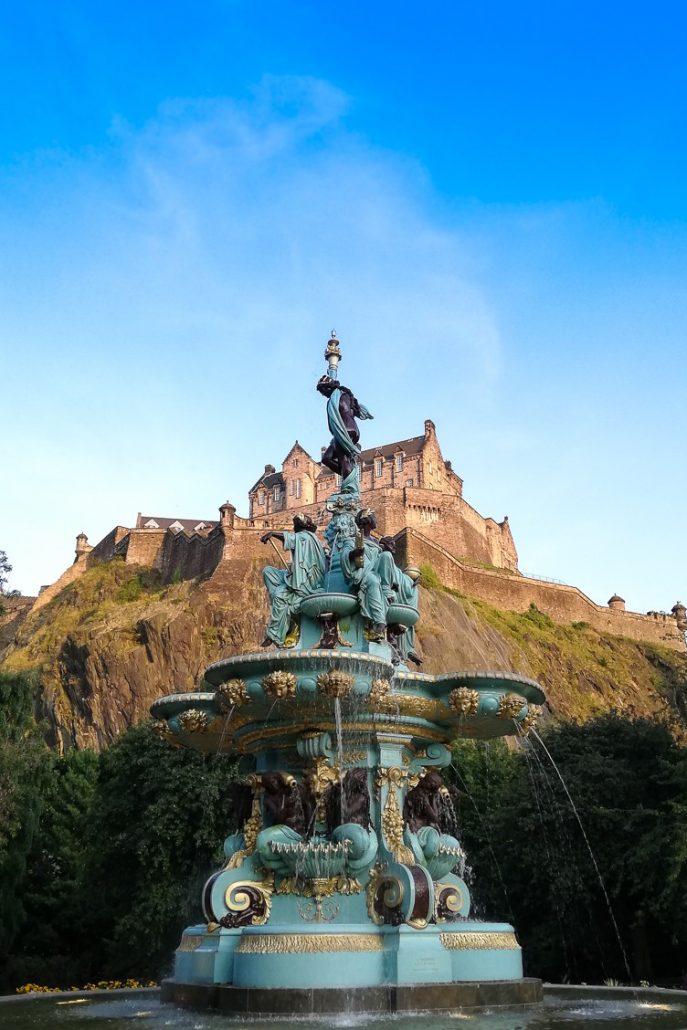 View of Edinburgh Castle in front of Ross Fountain in Princes Street Gardens