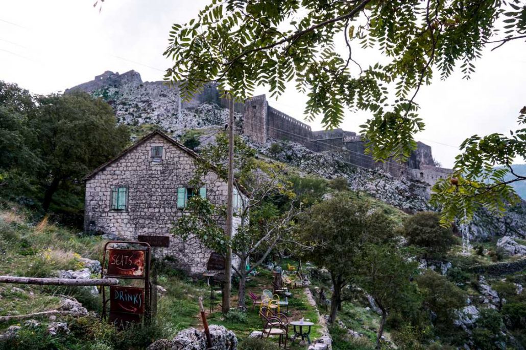 Photo of the first cafe right next to the old castle walls in the background