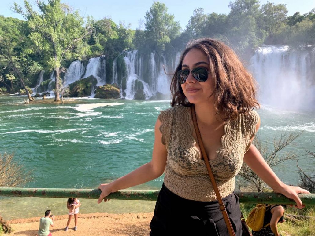 Photo of Gigi in front of the impressive Kravice Falls