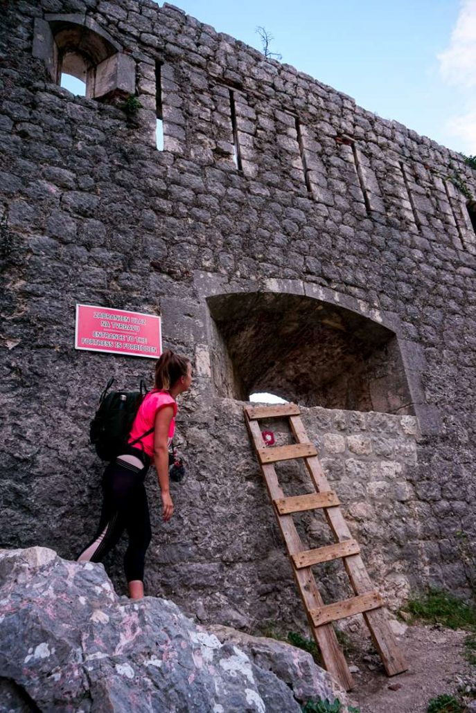 Photo of our friend Sandy peaking into the back exit of the Kotor Fortress