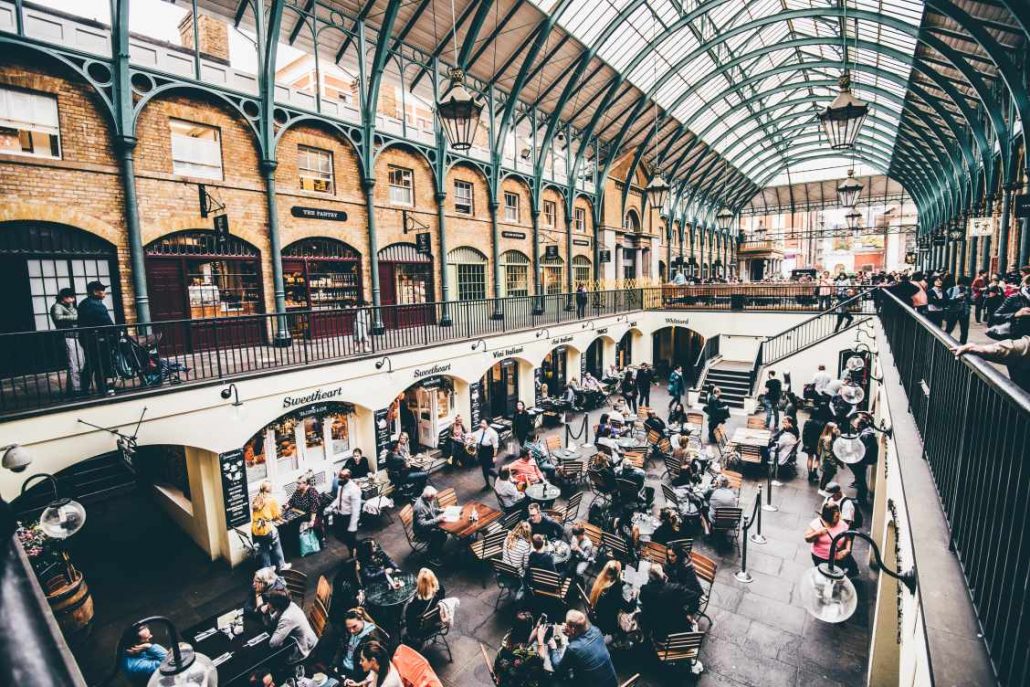 Covent Garden in London with lots of people enjoying the food and shopping on offer during their day out with kids