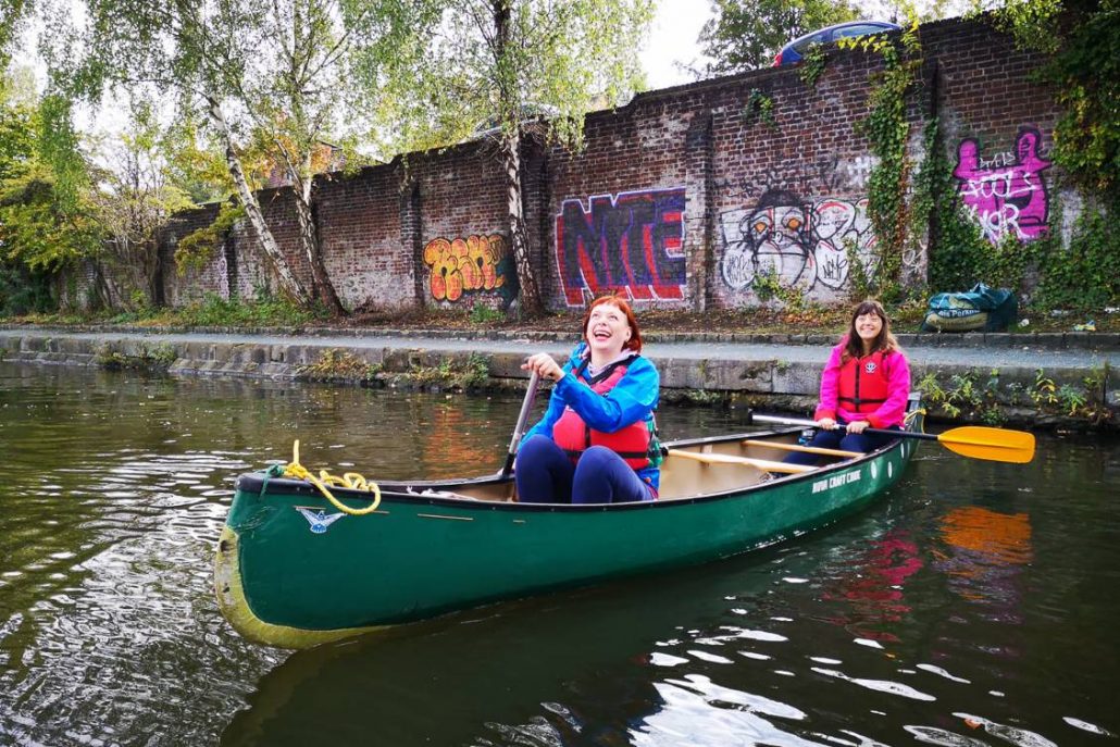 Alice Teacake and Jessica in Your Ear canoeing along Victoria Quays Sheffield on a microgap