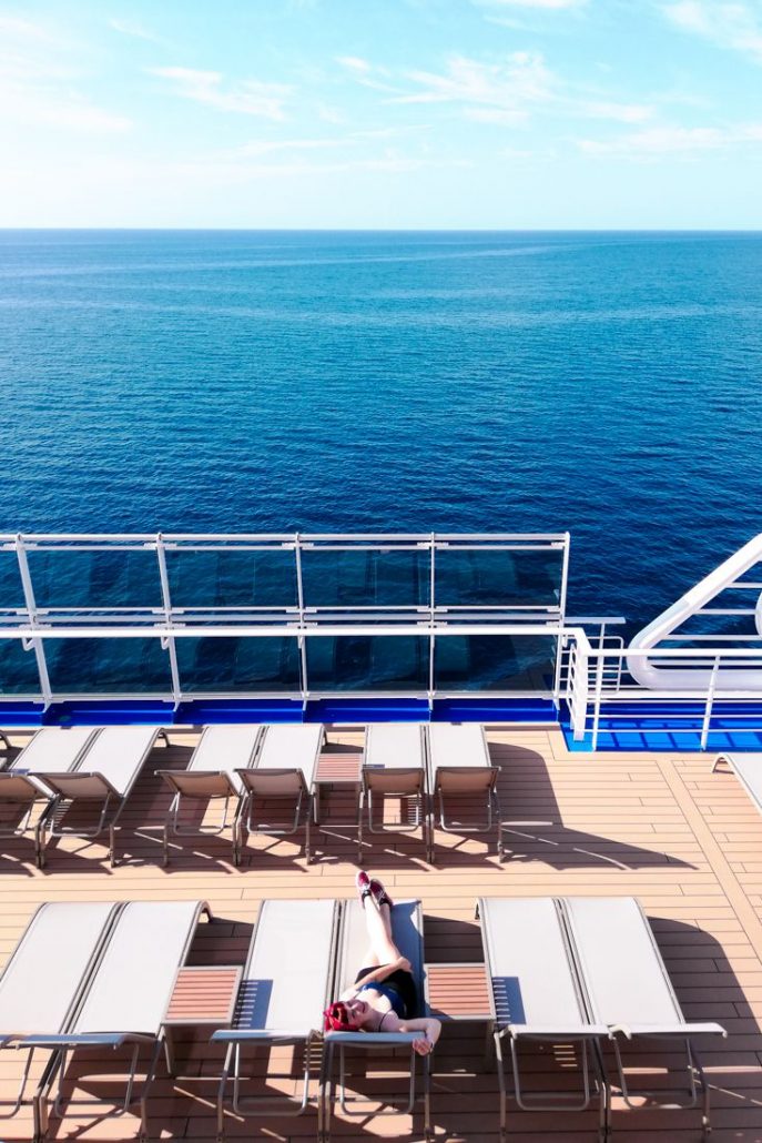 On the deck in the sun on a lounger looking out to sea