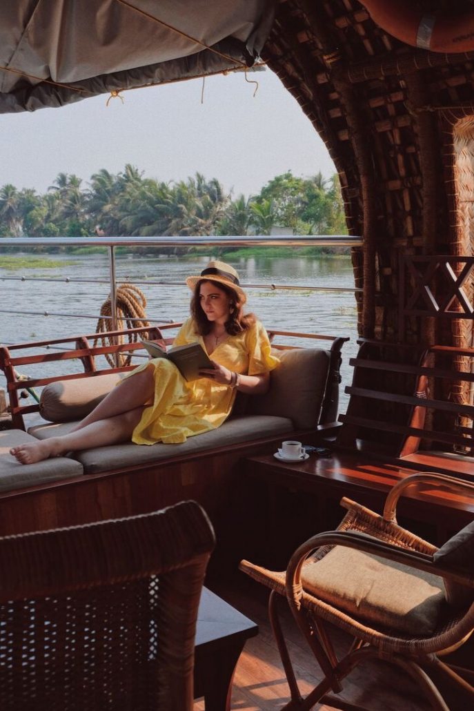 Woman reads a book on a houseboat