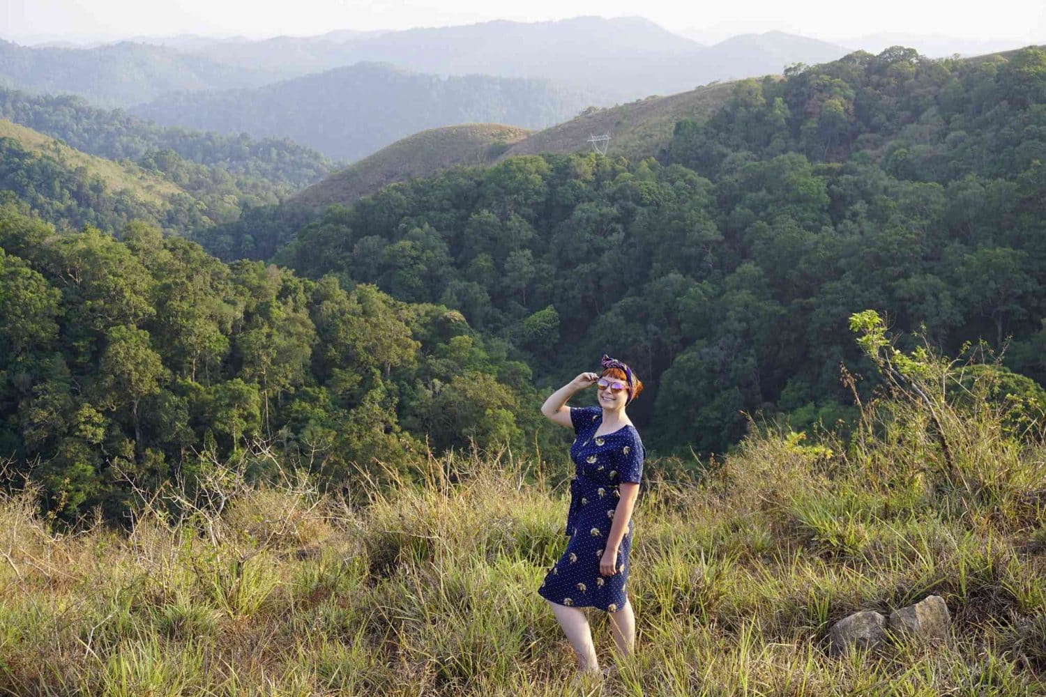 Alice Teacake looking out over the lush green hills of Kerala, India