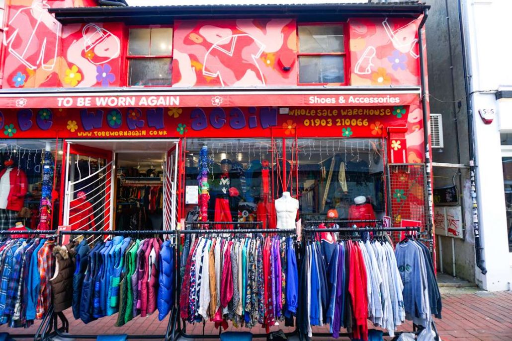 Front of To Be Worn Again Vintage Shop with plenty of jackets hanging on a rail outside